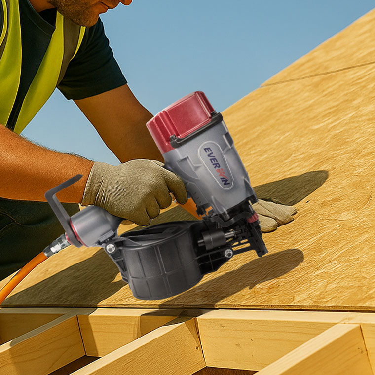 Worker using an EVERWIN PN65M-DOD coil nailer to install OSB sheathing on roof decking framework.